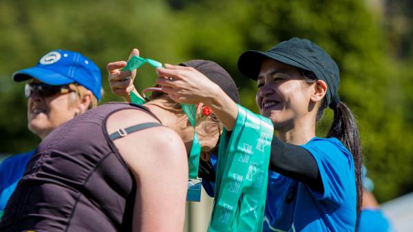 medal finisher happy volunteer